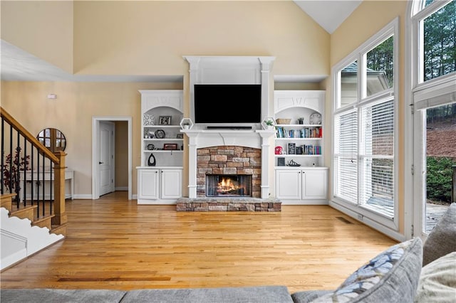 5955 Manchester Ln, Gainesville, GA 30506 - living area featuring light wood-style floors, high vaulted ceiling, healthy amount of natural light, stairs, and a fireplace