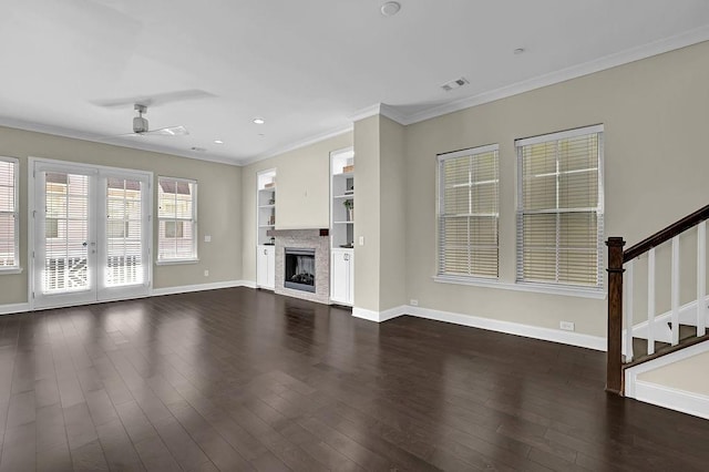 unfurnished living room with visible vents, ornamental molding, a ceiling fan, dark wood-style floors, and baseboards