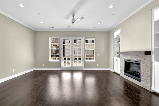 unfurnished living room featuring dark wood-style floors, built in shelves, a ceiling fan, and baseboards