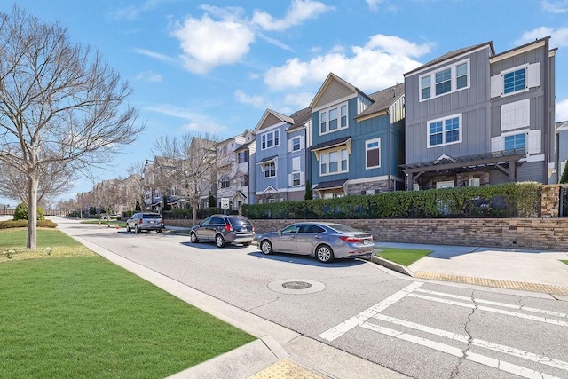 view of street with sidewalks, curbs, and a residential view