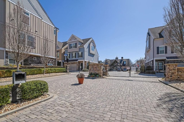 view of property's community with a residential view and a gate