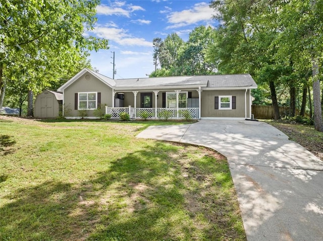 single story home featuring a front yard, a porch, and a shed