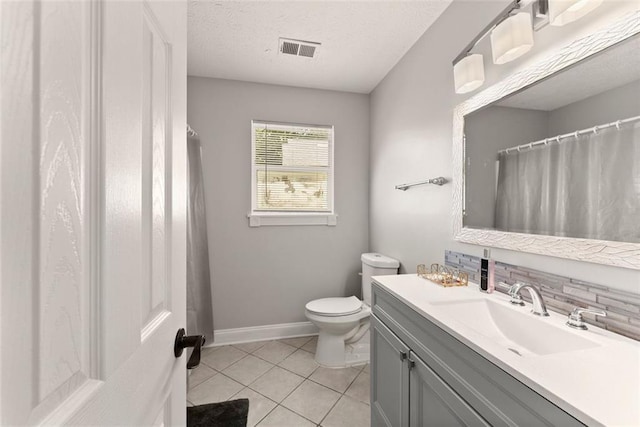 bathroom featuring tile patterned flooring, a textured ceiling, toilet, decorative backsplash, and vanity