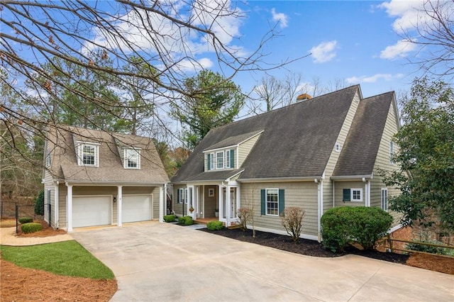 cape cod home with a garage