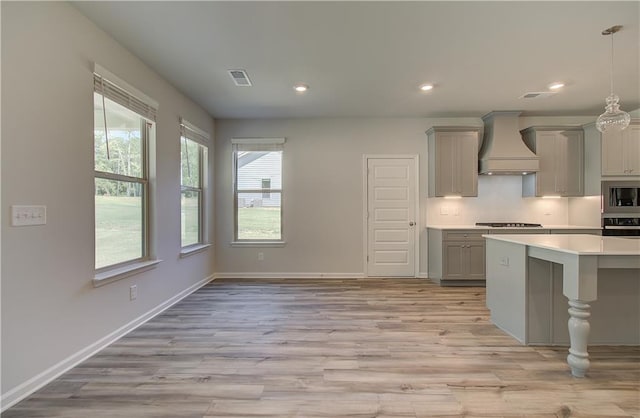 2516 Cadenza Cir, Dacula, GA 30019 - kitchen with custom range hood, gray cabinets, wall oven, built in microwave, and light countertops