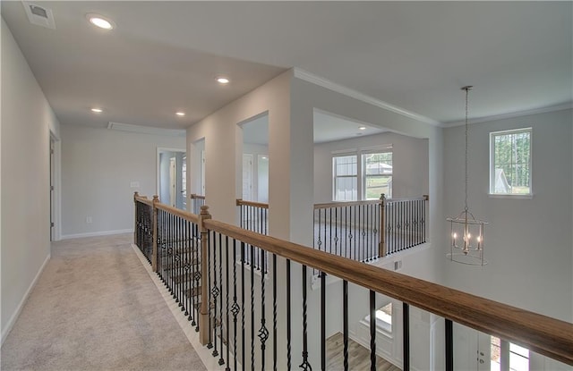 2516 Cadenza Cir, Dacula, GA 30019 - hall with a chandelier, an upstairs landing, ornamental molding, recessed lighting, and carpet floors