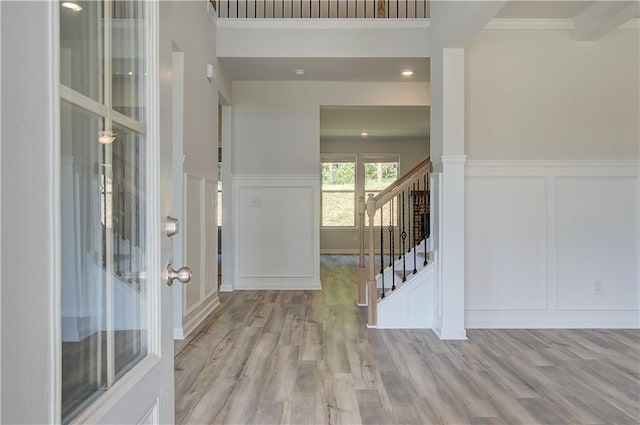 2516 Cadenza Cir, Dacula, GA 30019 - foyer entrance featuring a decorative wall, wood finished floors, stairs, wainscoting, and ornamental molding