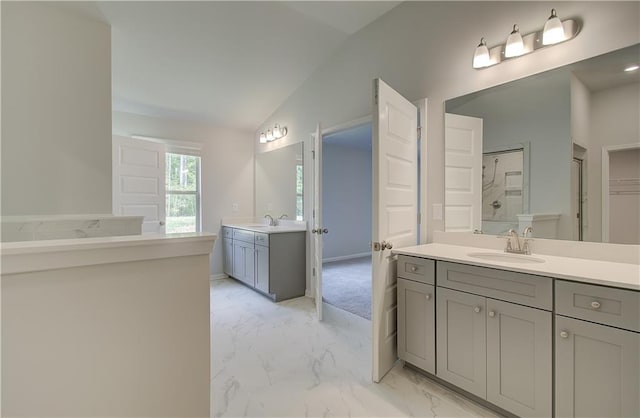 2516 Cadenza Cir, Dacula, GA 30019 - bathroom with lofted ceiling, marble finish flooring, two vanities, and a shower