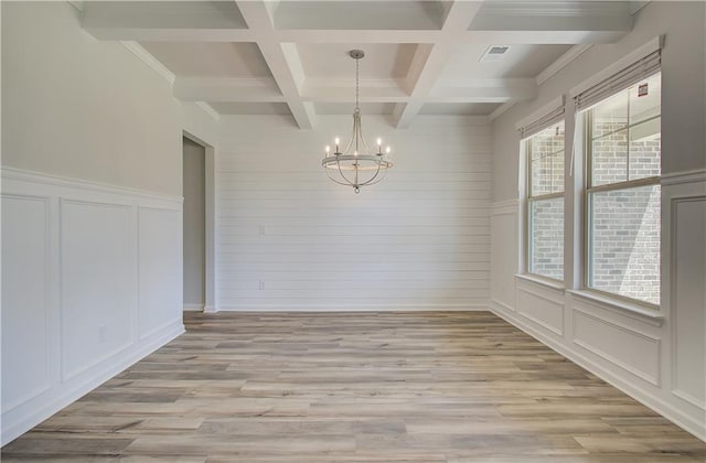 2516 Cadenza Cir, Dacula, GA 30019 - spare room with a decorative wall, beam ceiling, a chandelier, light wood finished floors, and coffered ceiling
