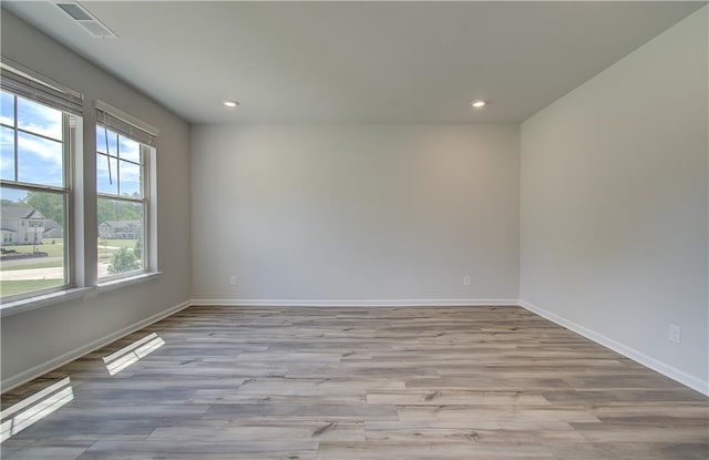 2516 Cadenza Cir, Dacula, GA 30019 - spare room featuring light wood-style flooring and recessed lighting
