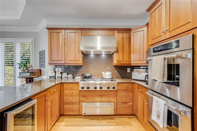 530 Twinflower Ct, Roswell, GA 30075 - kitchen with wall chimney range hood, appliances with stainless steel finishes, a warming drawer, wine cooler, and light wood-style flooring
