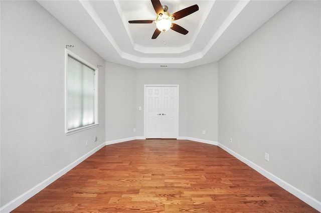 5600 Walnut Creek Ct NW, Lilburn, GA 30047 - unfurnished room featuring a raised ceiling, a ceiling fan, light wood-style floors, and baseboards
