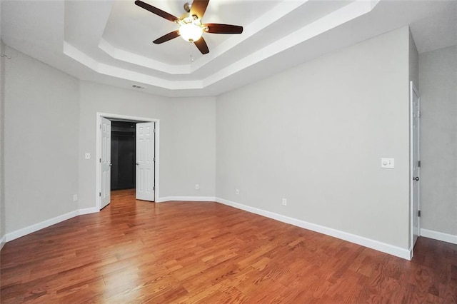 5600 Walnut Creek Ct NW, Lilburn, GA 30047 - unfurnished room with a raised ceiling, ceiling fan, wood finished floors, and baseboards