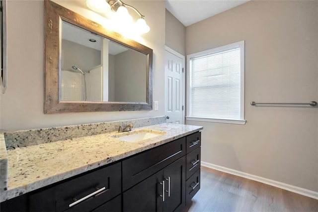 5600 Walnut Creek Ct NW, Lilburn, GA 30047 - bathroom with vanity, wood finished floors, and baseboards