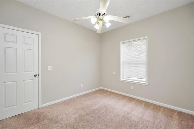 5600 Walnut Creek Ct NW, Lilburn, GA 30047 - spare room featuring light colored carpet, baseboards, and a ceiling fan