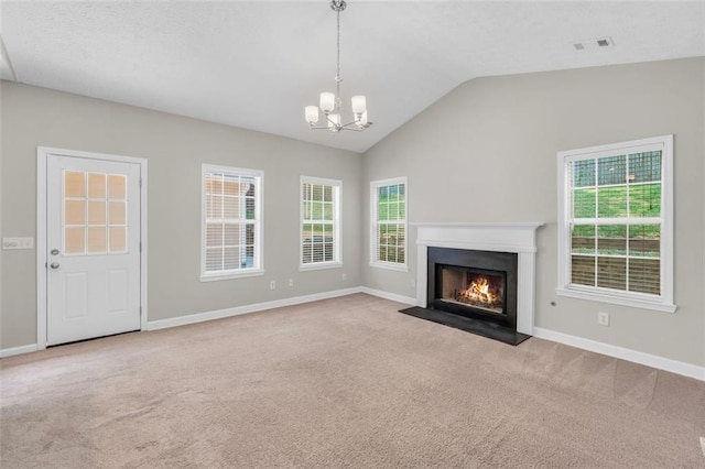 5600 Walnut Creek Ct NW, Lilburn, GA 30047 - unfurnished living room with carpet, a chandelier, baseboards, plenty of natural light, and lofted ceiling