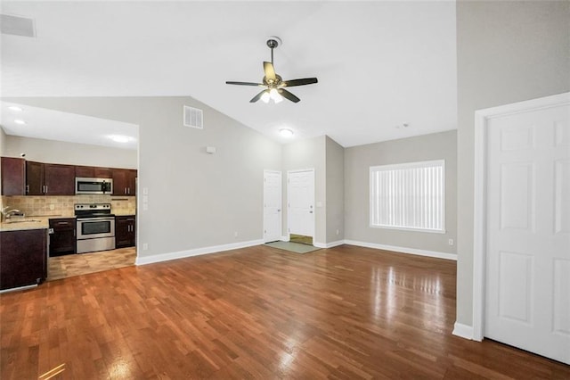 5600 Walnut Creek Ct NW, Lilburn, GA 30047 - unfurnished living room with a sink, a ceiling fan, lofted ceiling, wood finished floors, and baseboards