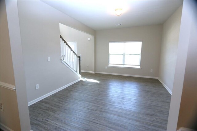 unfurnished room with dark hardwood / wood-style floors