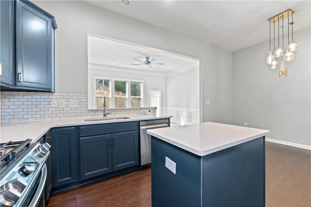 kitchen featuring blue cabinetry, sink, dark wood-type flooring, stainless steel appliances, and a kitchen island