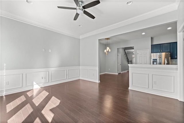 empty room with ceiling fan with notable chandelier, crown molding, and dark wood-type flooring