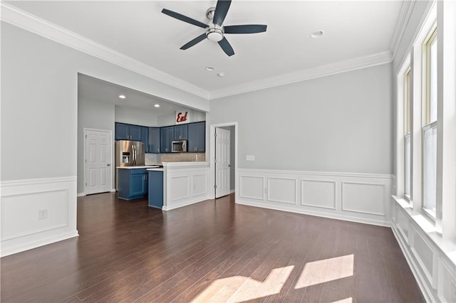 empty room with ceiling fan with notable chandelier, dark hardwood / wood-style floors, and ornamental molding