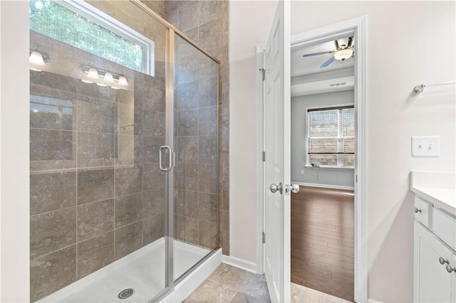 bathroom featuring ceiling fan, hardwood / wood-style floors, vanity, and a shower with door