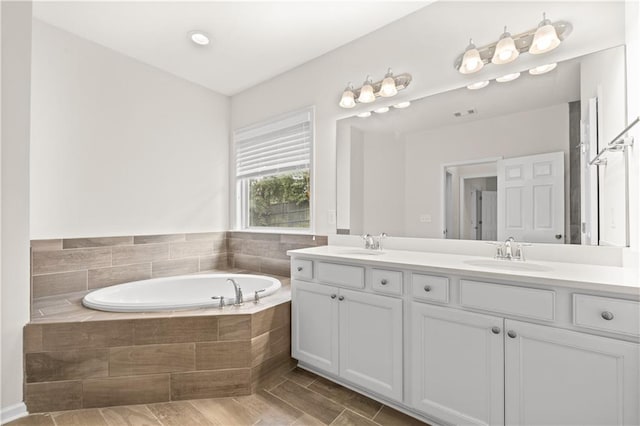 bathroom featuring vanity and plus walk in shower