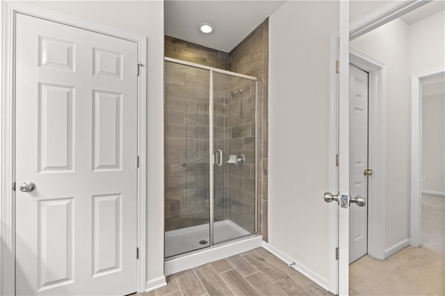 bathroom with a shower with shower door