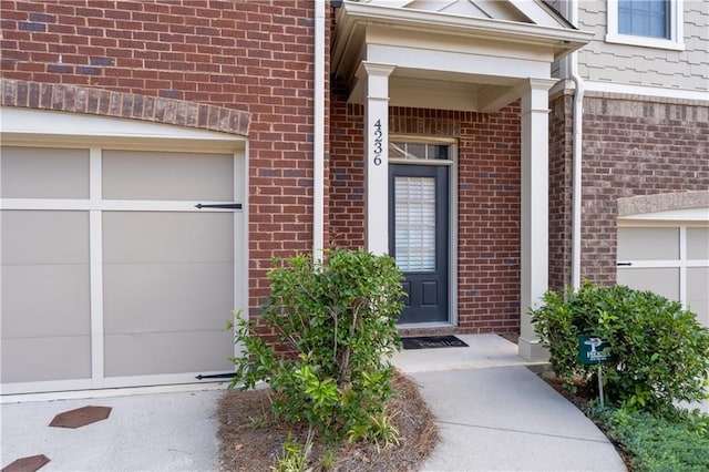 view of exterior entry with a garage