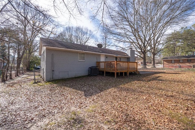 back of house with cooling unit and a deck