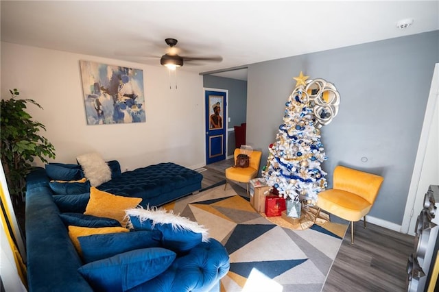 living room featuring ceiling fan and hardwood / wood-style flooring