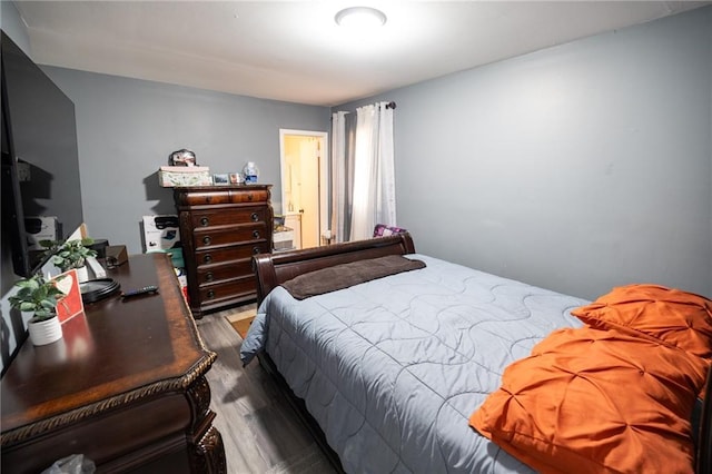 bedroom with hardwood / wood-style floors