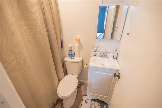 bathroom featuring hardwood / wood-style floors, vanity, and toilet