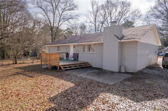 rear view of house featuring a deck and a patio area