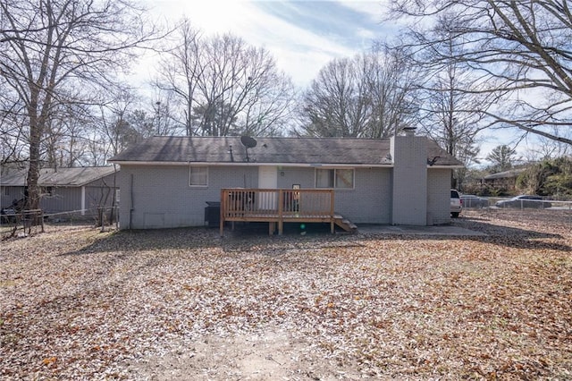 back of house featuring a wooden deck