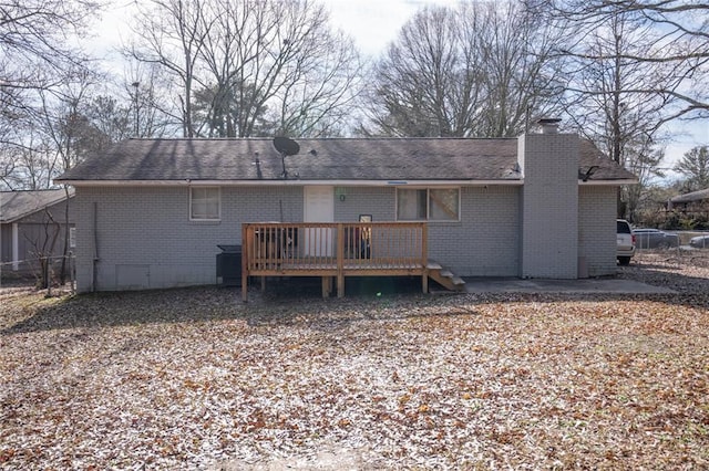 back of house with a wooden deck