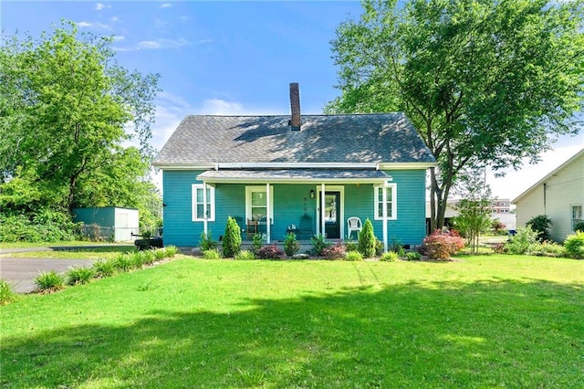 5150 Wheat St NE, Covington, GA 30014 - view of front of home with a porch, a front lawn, and a chimney