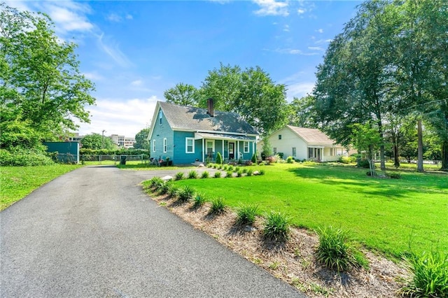 5150 Wheat St NE, Covington, GA 30014 - view of front of home featuring a chimney and asphalt driveway