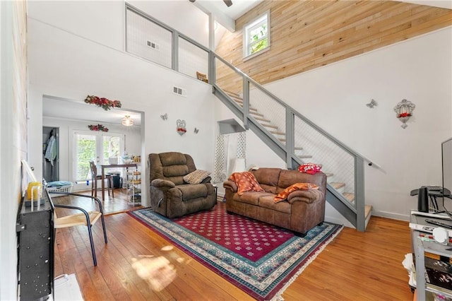 5150 Wheat St NE, Covington, GA 30014 - living room featuring stairway, wood-type flooring, a high ceiling, and french doors