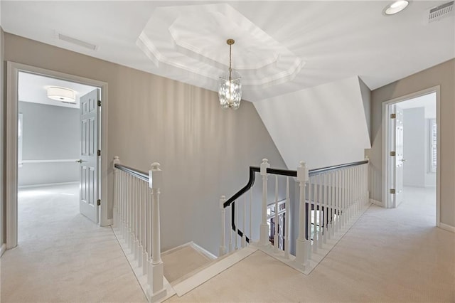 stairs with an inviting chandelier, baseboards, visible vents, and carpet floors