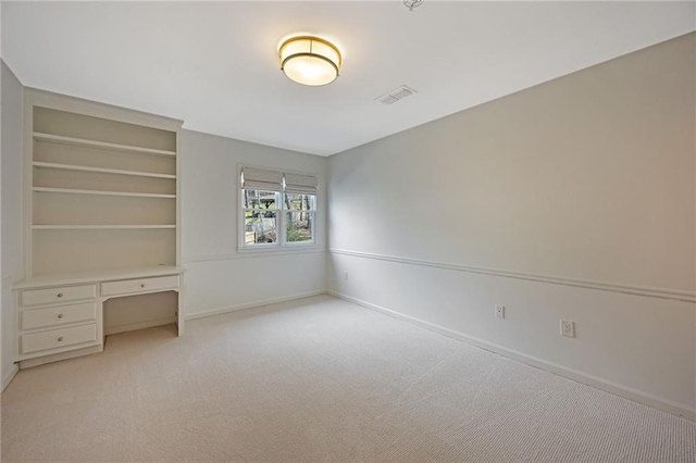 unfurnished bedroom featuring visible vents, baseboards, and light colored carpet