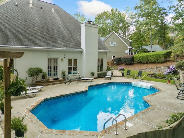 view of pool with a patio area, french doors, and a fenced in pool