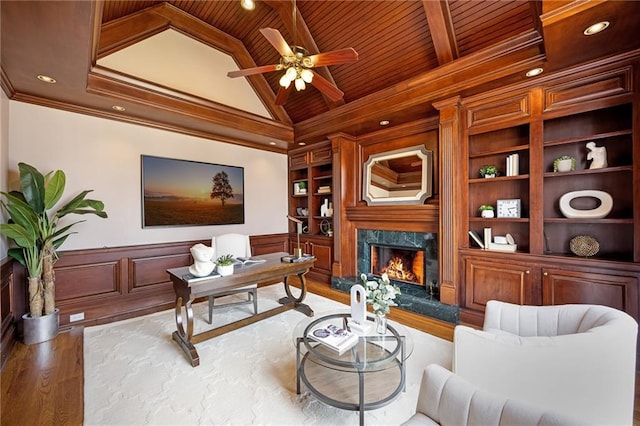 office area featuring a high end fireplace, crown molding, built in features, wainscoting, and wooden ceiling