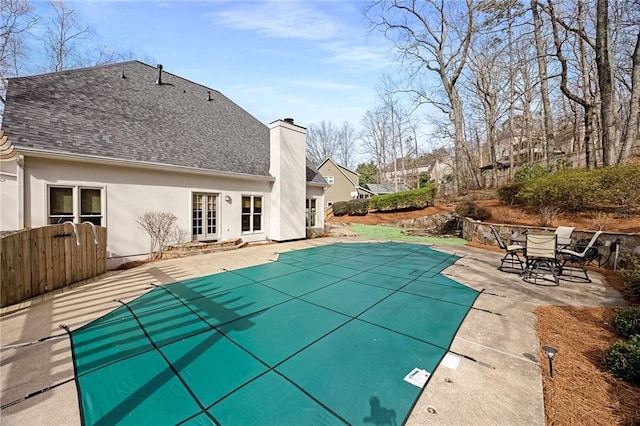 view of swimming pool featuring a patio, a fenced in pool, and fence