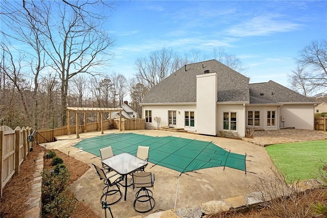 view of pool with a patio area, a fenced in pool, a fenced backyard, and a pergola