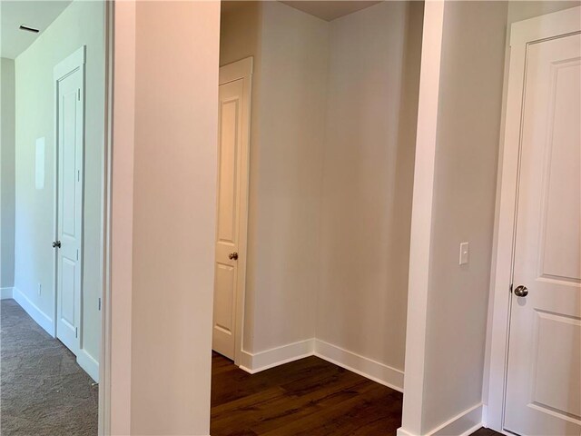 hallway with dark hardwood / wood-style flooring