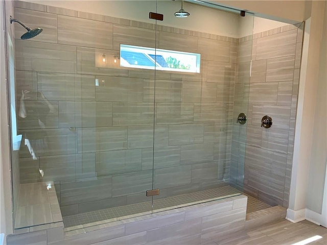 bathroom with walk in shower and hardwood / wood-style floors