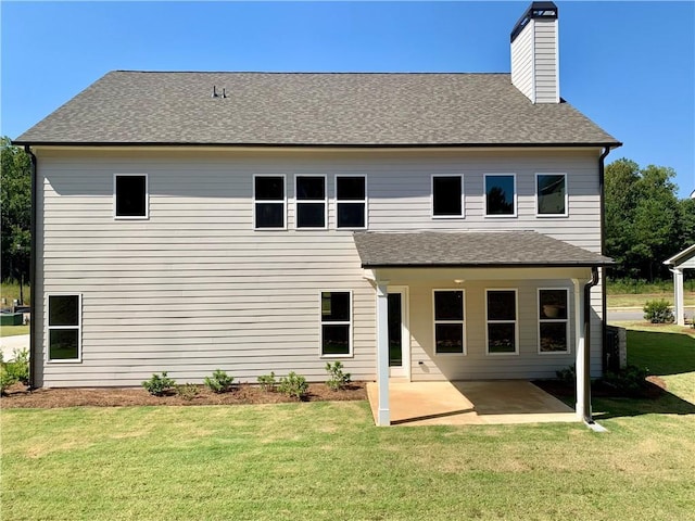 back of house with a patio and a yard