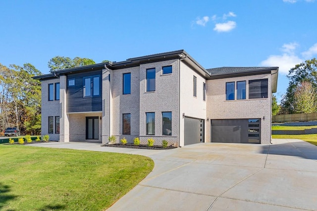 view of front of house featuring a front lawn and a garage