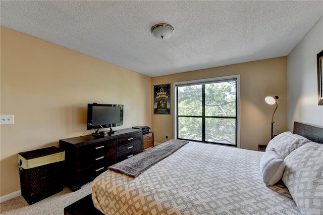 bedroom with baseboards, a textured ceiling, and light colored carpet